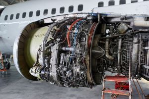 aircraft engine servicing - opened panels of a large engine of parked aircraft.