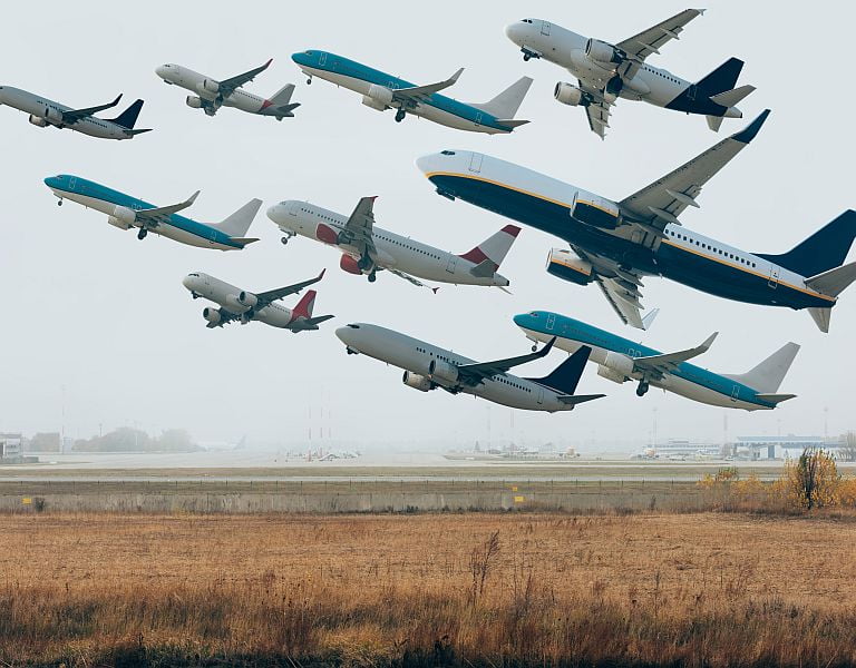 Cloudy sky with airplanes above airport runway