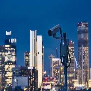 Security camera against urban skyline