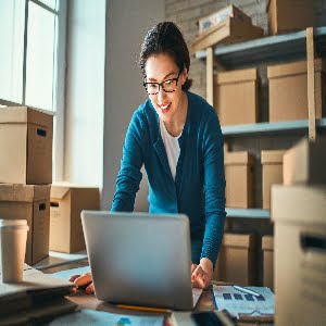 Woman is working at warehouse for online store.